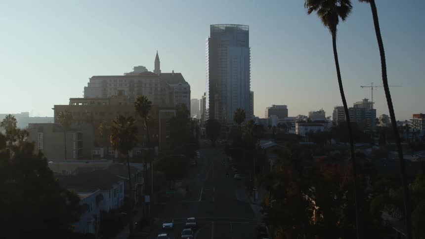 Aerial view of city skyscrapers highways and vehices at dawn