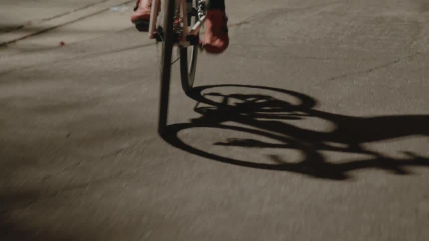Bikers with red and white shoes ride bicycles on highway