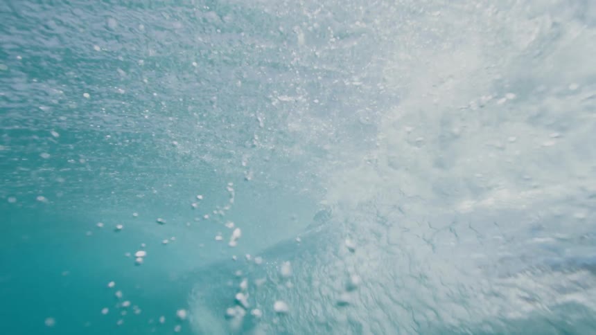 A large wave in the ocean rolling to the shore