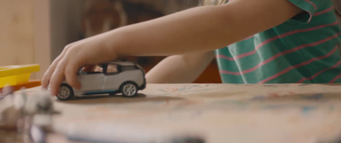 A child playing with a toy car