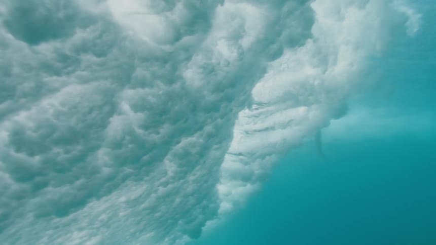 A person is surfing in the ocean water