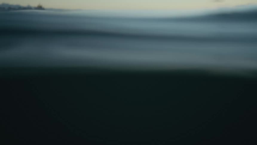 Ocean waves are moving calmly at dusk