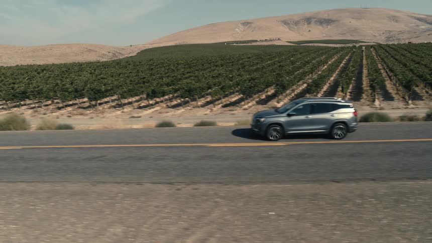 A car drives past the huge farm