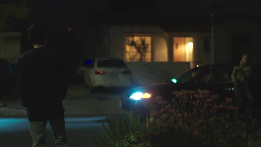 Mother gets out of a car and runs over and hugs her injured son who is bleeding near his eye