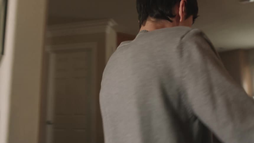 A boy takes a deep breath and psyches himself up before bringing something to his mother