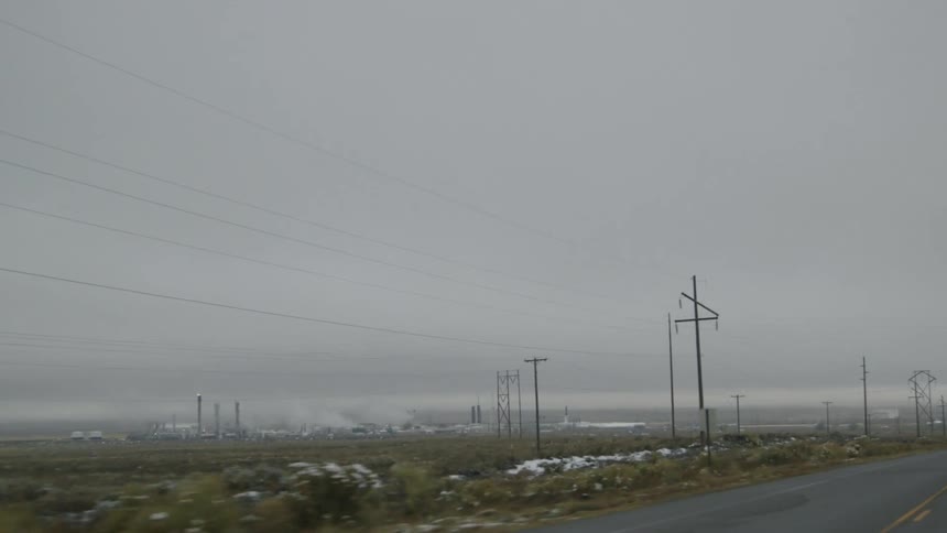 Driving alongside factory in winter