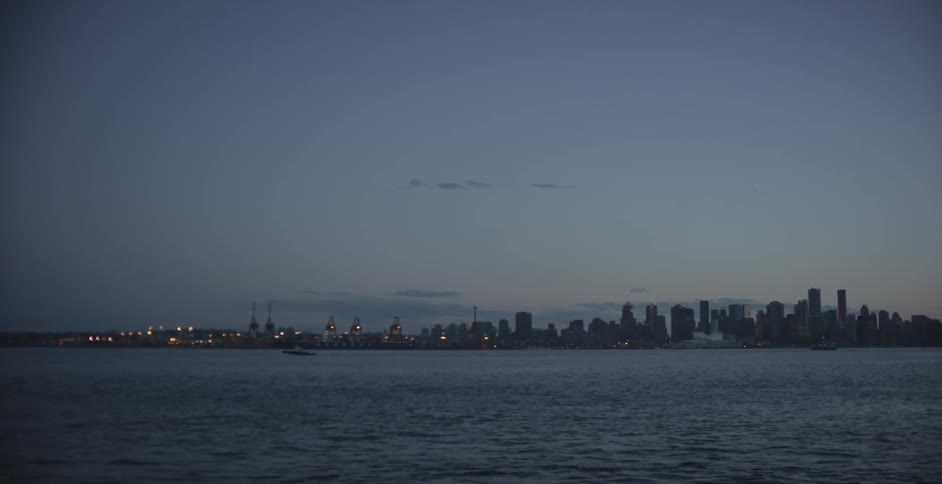 A city is across the water at sunset