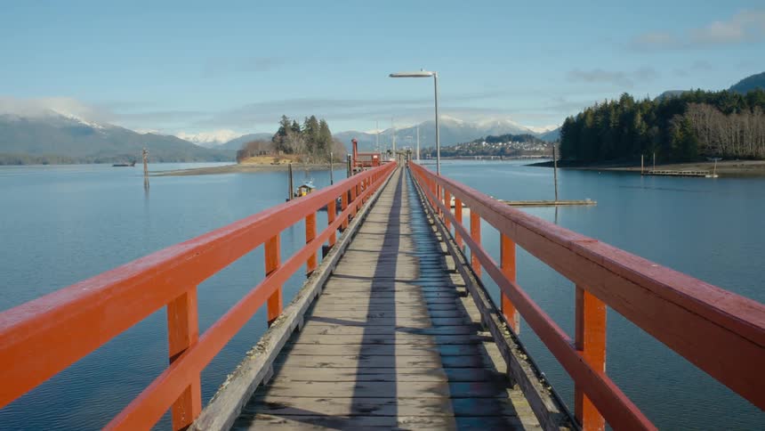 A wooden bridge is over the river