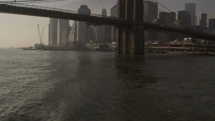 A bridge over a body of water near a city
