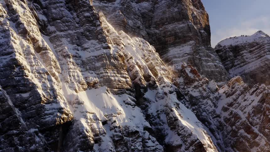 The side of a snowy mountain on a cloudy day