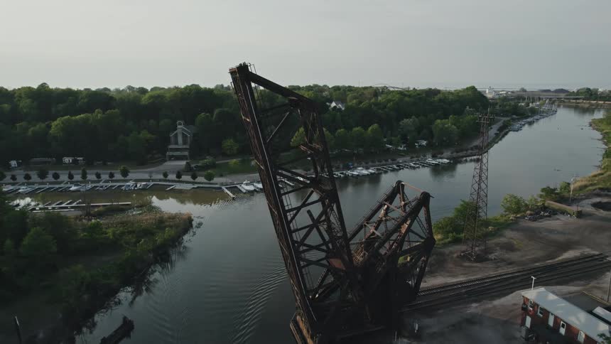 A raised railway drawbridge over a river on a cloudy day