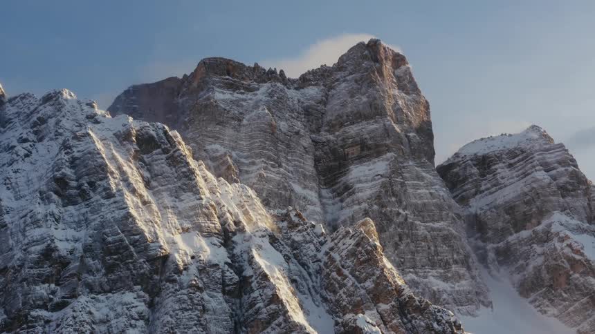 A dusting of snow covers the side of a canyon