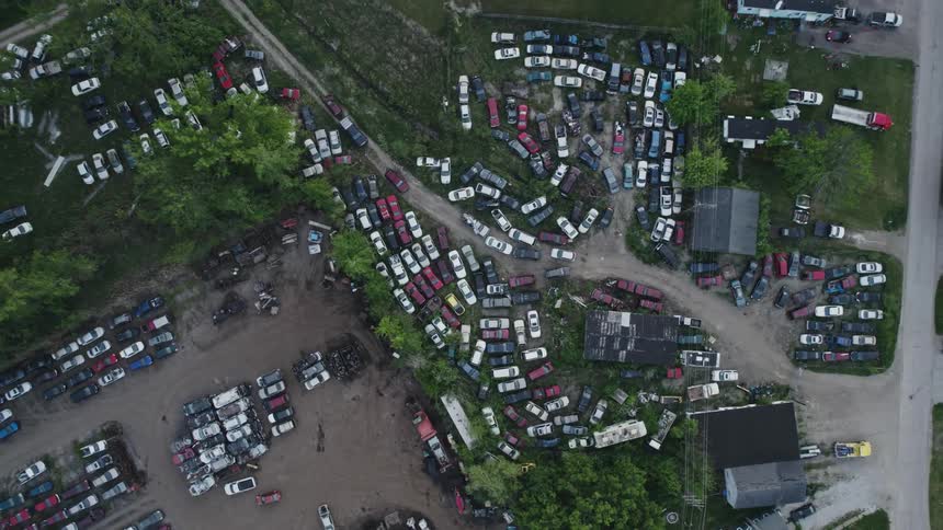 Aerial view of parking lots filled with cars and roads leading to them
