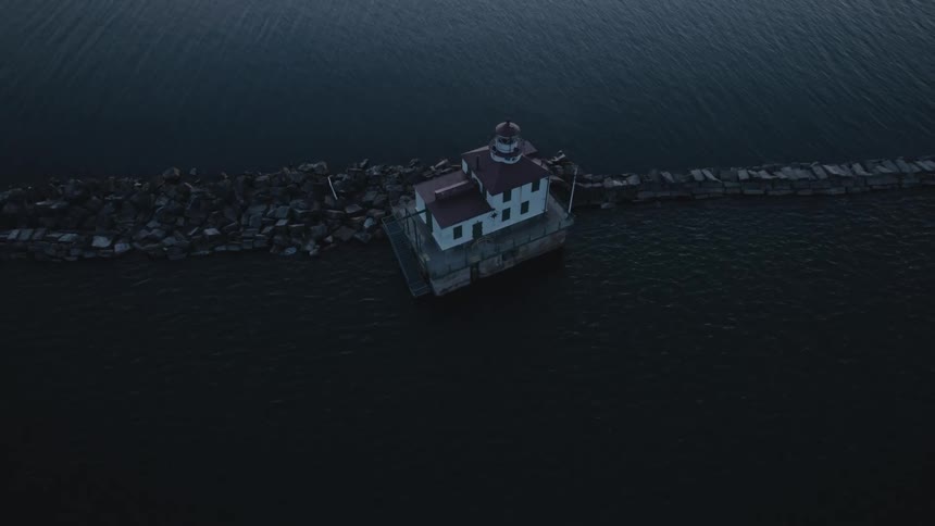 Aerial view of a lake house is displayed