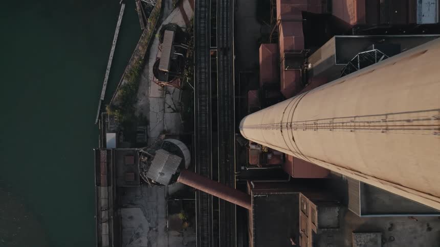 Aerial view of a factory tower along the coast