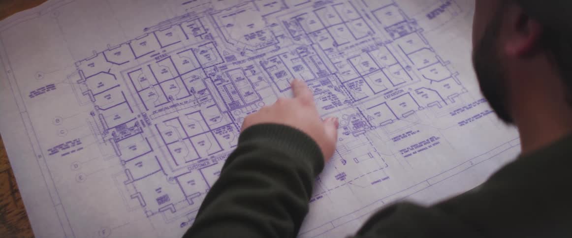 A man is looking at a diagram on the table
