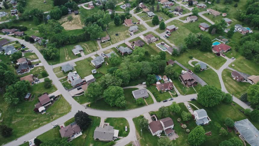 Homes sit on large lots in a suburban neighborhood