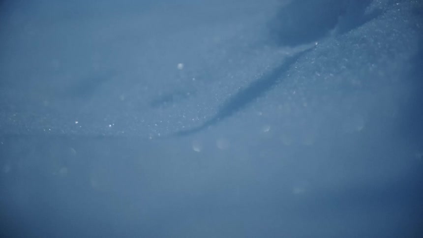 ice crystals blowing over the ground with wind