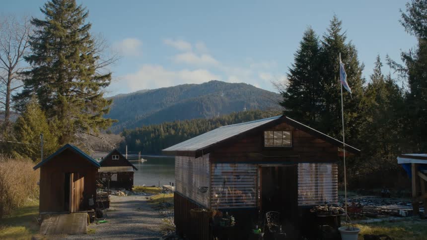 A group of cabins on the shore of a lake on a sunny day
