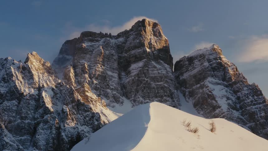 Light snow cover accents rock formations and mountains