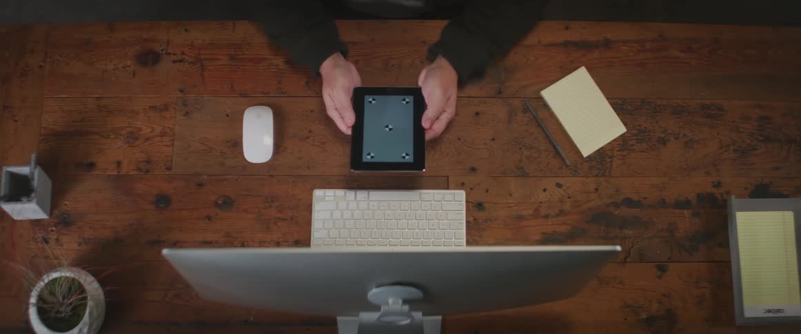 A person turns on a computer tablet and looks at the screen for a while before turning it off and sitting it down