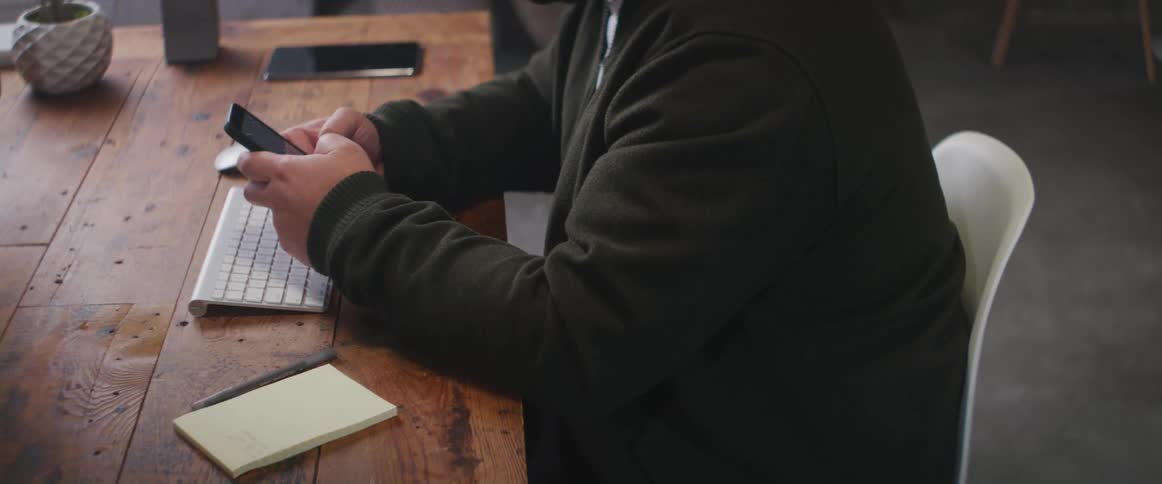 A man is using his cell phone in the office