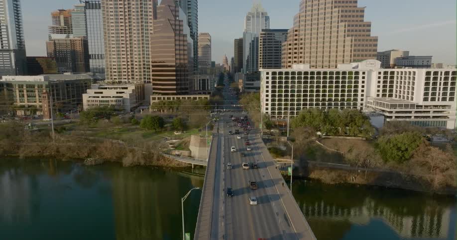 Cars travel on the bridge over the river in the city