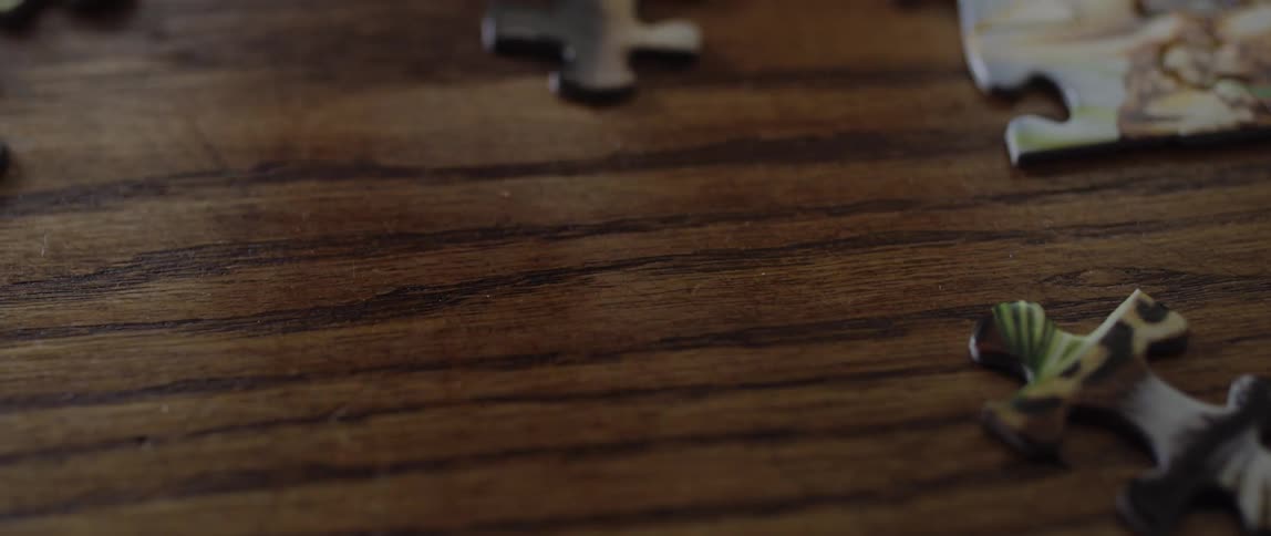 A person is putting together a puzzle indoors