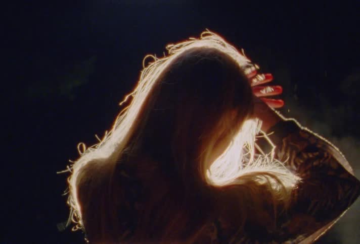 A light is flashing in a womans face on stage