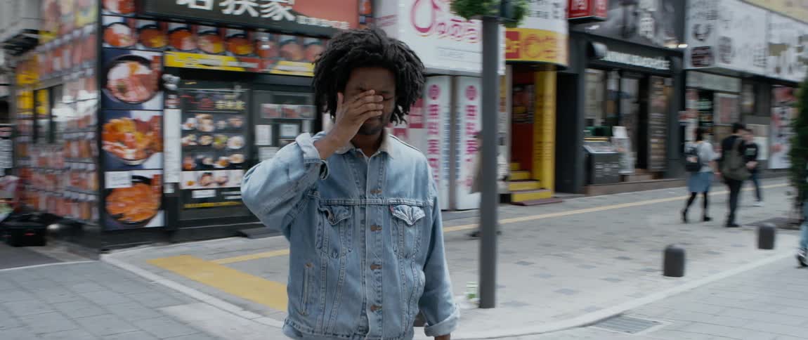 A man gets up and walks down the street