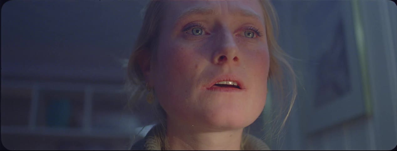 A woman keeps looking down at something she is doing and she looks upset and bothered