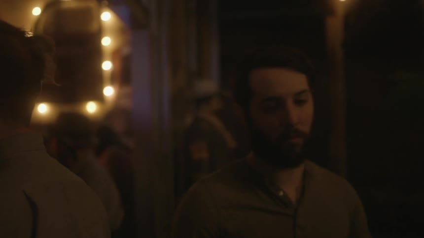 A man walks out of a club at night