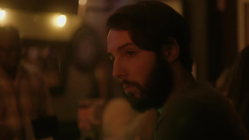 A man turns his head in a bar