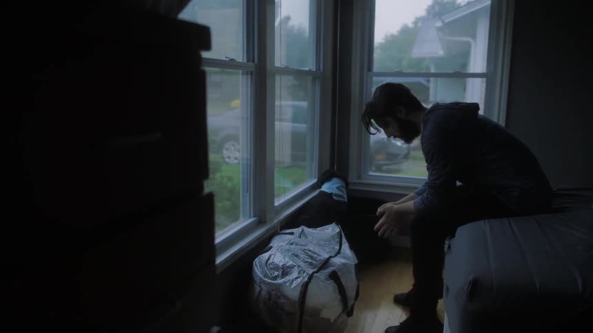 A man sits on a bed