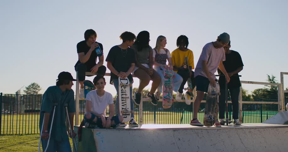 A group of friends are at a skate park together