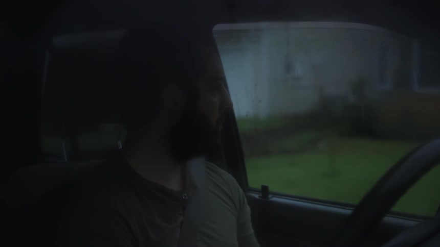 A man looks out his car window