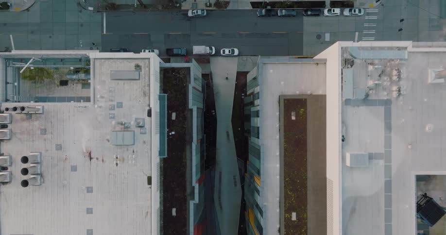 Top down traverse over the narrow breezeway between modern biotech buildings