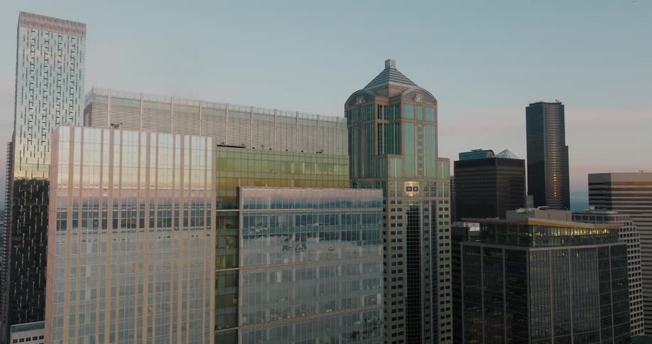 Beautiful golden light shimmers from the glass and steel of tall skyscrapers