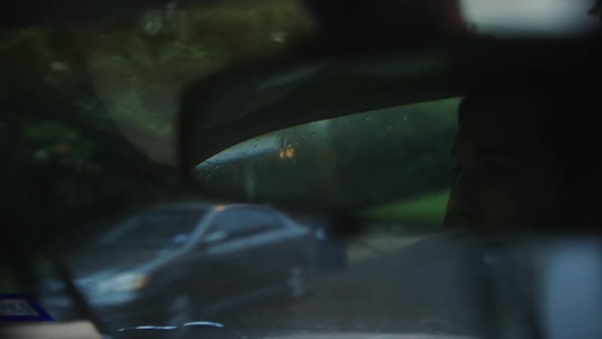 Close up of a rear view mirror inside of a moving car