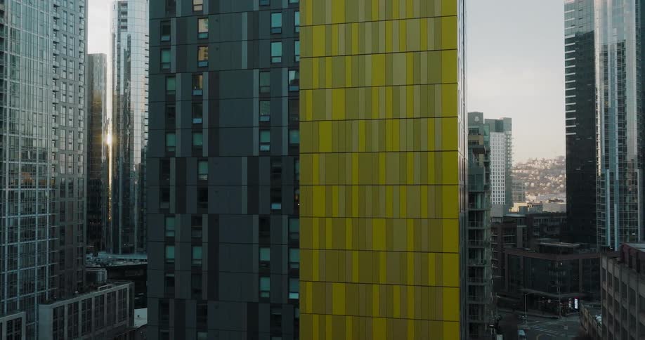 Pullback reveal of an urban city center from the side of a new condo tower