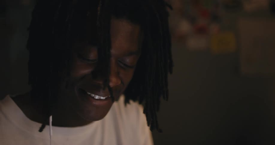 A man in a room with headphones in