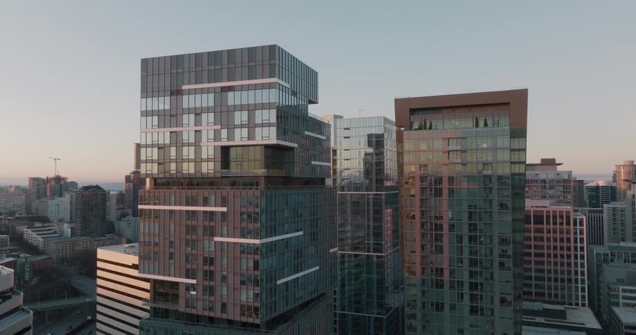 Ascending along the glass and steel of modern high rise apartment towers in a big city
