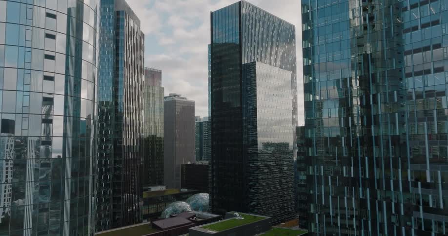 Pushing between modern steel and glass skyscrapers in a large city
