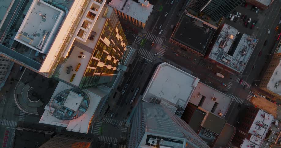 Birds eye view of city life in the deep urban canyons between downtown buildings