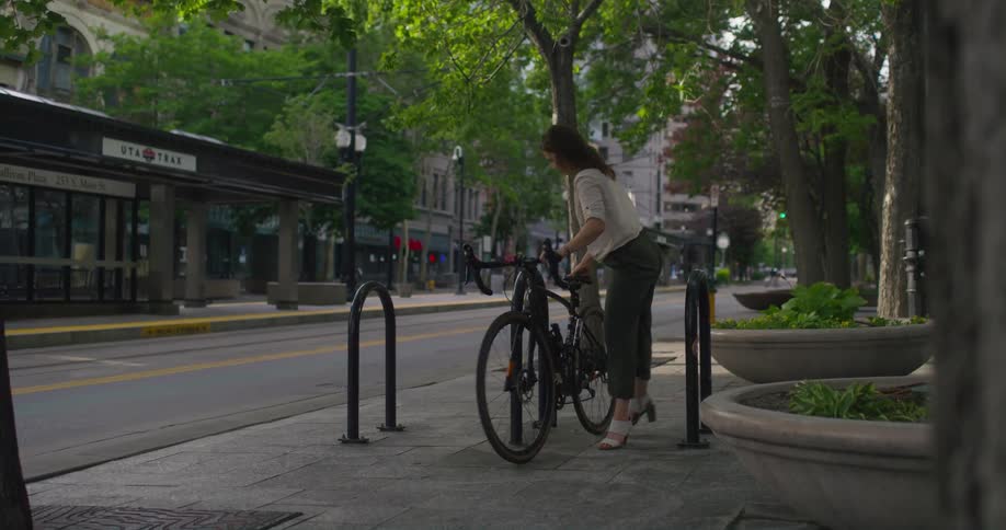 A woman is biking in a neighborhood in spring