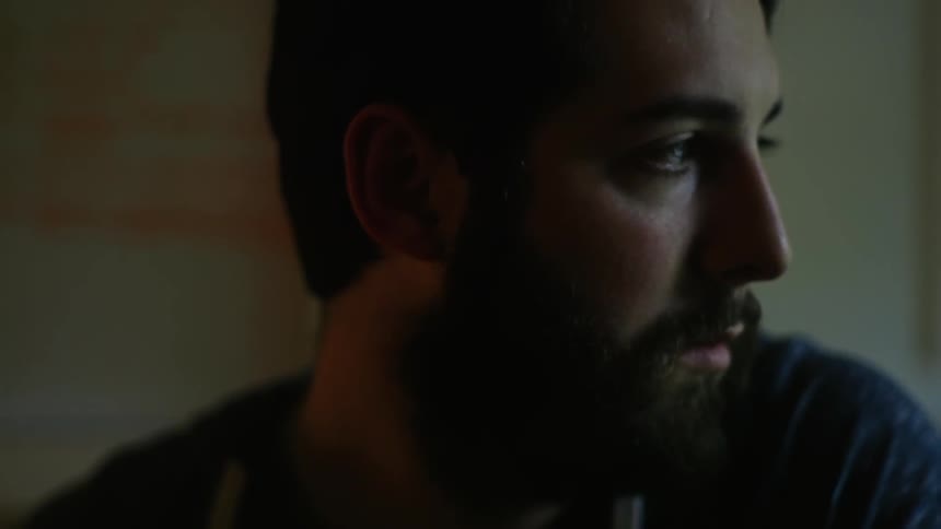 A bearded man looks up