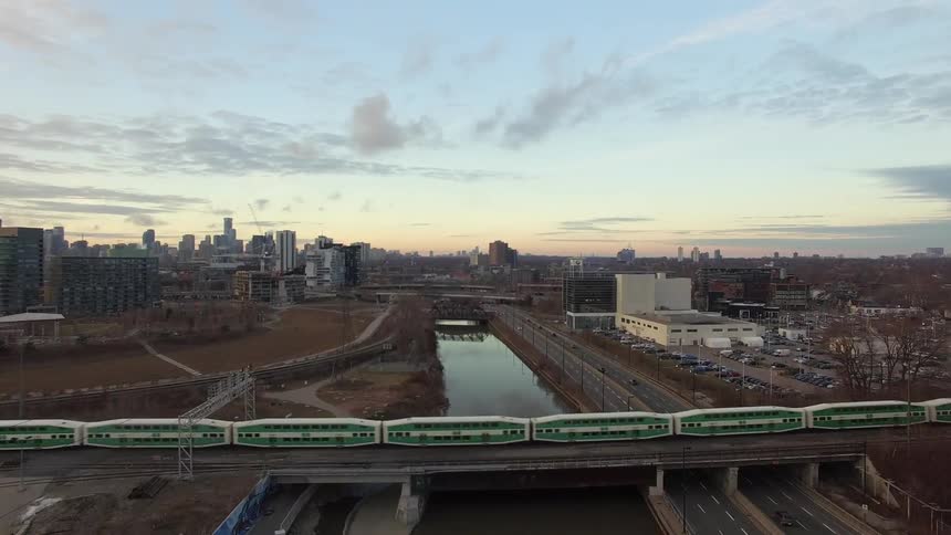 A train travels over a bridge covering a canal