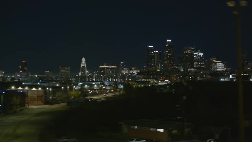 Tall city buildings light up the city skyline at night