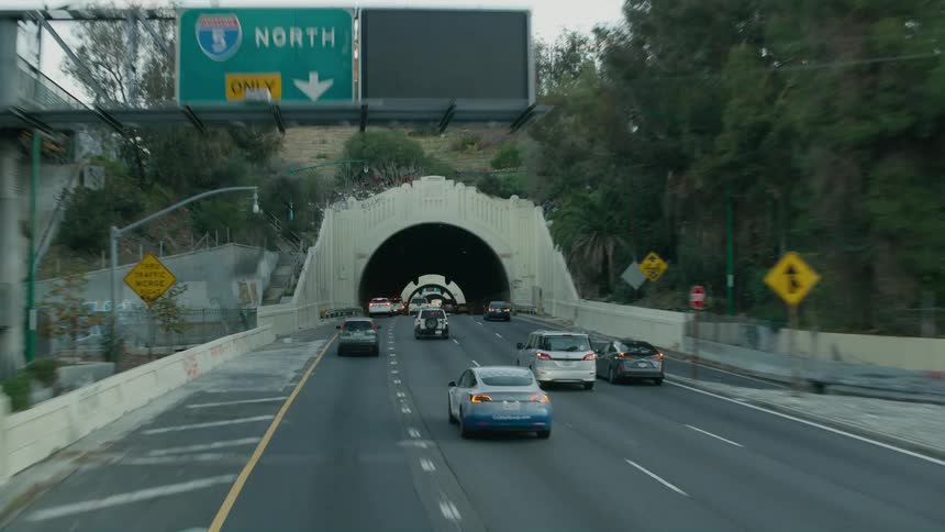 Traffic travels through tunnels on a freeway