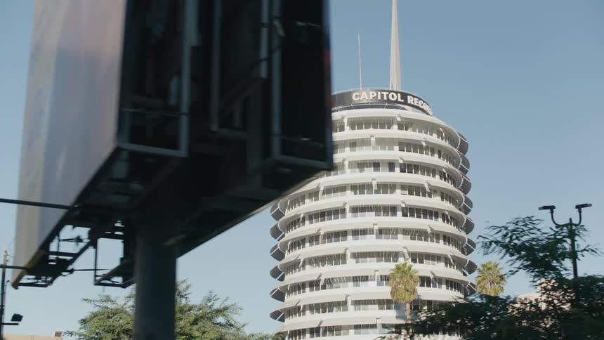 The tall buildings has a banner at the top